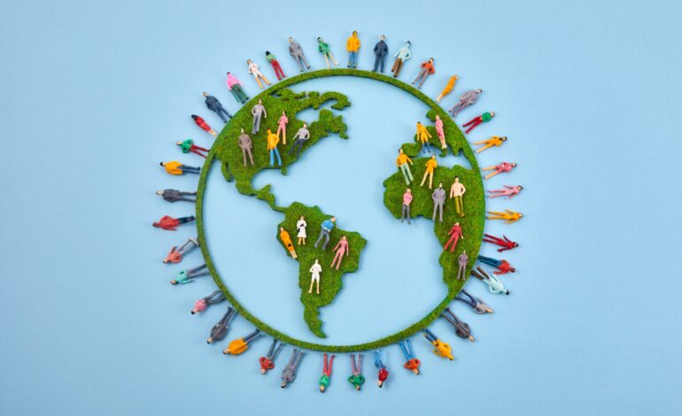 World Population Day, creative concept. Large and diverse group of people in the shape of the world